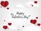 Valentines day background of many tiny red hearts on white sky background with clouds and Happy Valentines day text. Concept of