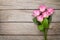 Valentines day background with pink roses over wooden table