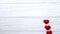 Valentines day background with red hearts, stop motion animation with copy space, frame, border. Love hearts on the white wooden b