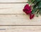 Valentines day background with red roses on wood