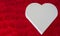 Valentines day background a white wooden heart laying on a red pillow