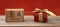 Valentines day. Calendar wooden cubes, 14 February and a gift box on wooden table, red wall