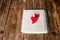 Valentines Day card with hearts and notepad on wooden background