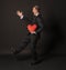 Valentines day cavalier with a beautiful heart in a black suit, black background