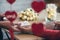 Valentines day.  Close-up of woman and man celebrating in restaurant. Boyfriend giving small box gift to girlfriend. View through