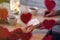 Valentines day.  Close-up of woman and man celebrating in restaurant. Boyfriend giving small box gift to girlfriend. View through