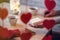 Valentines day.  Close-up of woman and man celebrating in restaurant. Boyfriend giving small box gift to girlfriend. View through