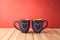 Valentines day concept with chalkboard coffee mugs and heart shapes on wooden table