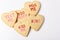 Valentines Day Concept: Closeup of five Heart shaped sugar cookies with different sayings written in icing