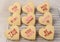 Valentines Day Concept: Closeup of nine Heart shaped sugar cookies with sayings standing in a cooling rack