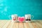 Valentines day concept with coffee cup funny characters and heart shape on wooden table over blue background