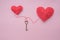 Valentines day concept. Creative valentines day conception made by reto key and red hearts isolated on pink background
