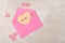 Valentines Day Concept: High angle Heart shaped sugar cookie in a pink envelope with pink hearts and copy space