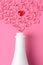 Valentines Day Concept: high angle shot of a white champagne bottle with pink glass hearts simulating a spray