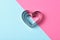 Valentines Day Concept: Nested Heart shaped cookie cutters on pink and blue with copy space