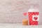 Valentines day concept with paper coffee cup and macarons. Romantic coffee shop