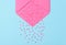 Valentines Day Concept: A pink envelope on a blue background with pink candy hearts