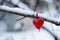 Valentines Day concept Red heart on snowy branch, close up