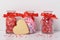 Valentines Day Concept: Three jars of holiday candies with a heart shaped sugar cookies and sprinkles