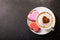 Valentines day.  Cup of cappuccino coffee with drawn heart and colorful heart shaped cookies, top view