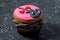 Valentines day cupcake  on black mottled background - fun cartoon face cupcake