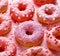 Valentines day  donuts with icing and sugar sprinkles on a pink backgValentine`s Day hot chocolate with heart-shaped marshmallows.