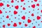 Valentines Day festive pattern. Red hearts on baby blue background