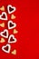 Valentines day food background. Heart shaped Linzer cookies with jam and icing sugar on a red background.