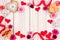 Valentines Day frame of hearts, flowers, gifts and decor on white wood