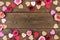 Valentines Day frame of hearts and roses against rustic wood