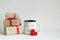 Valentines day gift boxes, toy heart and coffee cup with cutest funny eyes on white background, cute holiday breakfast concept