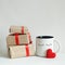 Valentines day gift boxes, toy heart and coffee cup with cutest funny eyes on white background, cute holiday breakfast concept