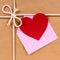 Valentines day gift with heart shape card or gift tag, brown paper package parcel background