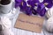 Valentines day greeting card iris purple flower coffee cup marshmallow and lettering.