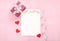 Valentines day greeting card with pink gift box white bow long curved ribbon and paper red hearts