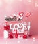 Valentines day greeting objects composing with gift box, roses bunch and hearts in shopping bag, text Love youu and ribbons