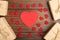 Valentines Day greetings concept. Little red wooden crafted hearts and gift boxes on the wooden background. Valentines greeting