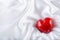 Valentines day. Hand made valentine heart. Wedding day. Red valentines hearts on white satin. Text: I love you