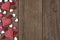 Valentines Day heart shaped candy side border on rustic wood