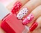 Valentines Day holiday manicure with painted hearts and polka dots