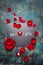 Valentines day lettering background on chalkboard with red hearts and rose petals, top view