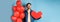 Valentines day and love concept. Man dreaming of soulmate, holding big red heart cutout and balloons, standing over blue