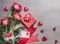 Valentines day, love or dating concept. Red roses bunch with gift box, blank paper greeting card and hearts , top view