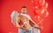 Valentines Day male. Sexy angel man with angels wings. Arrow of love, cupid, amour. February 14.  on red.