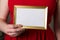 Valentines day mock up,woman holding empty frame in hands closeup