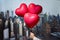 Valentines day in the New York city. man hand holding three reds balloons in form of heart over Manhattan and skyscrapers.