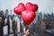 Valentines day in the New York city. man hand holding three reds balloons in form of heart over Manhattan and skyscrapers.