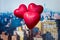 Valentines day in the New York city. Three red balloons in form of heart flying over Manhattan and skyscrapers. Ð¡oncept. America