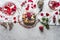 Valentines day with pastry with berries, sparkling wine with currants, jewelry and golden cutlery at grey table. Romantic date