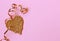 Valentines Day pink paper background, gold heart